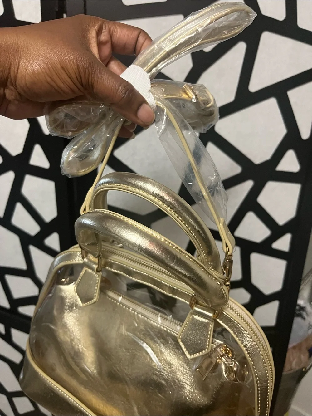 Gold clear two and one purse with handles and gold straps.
